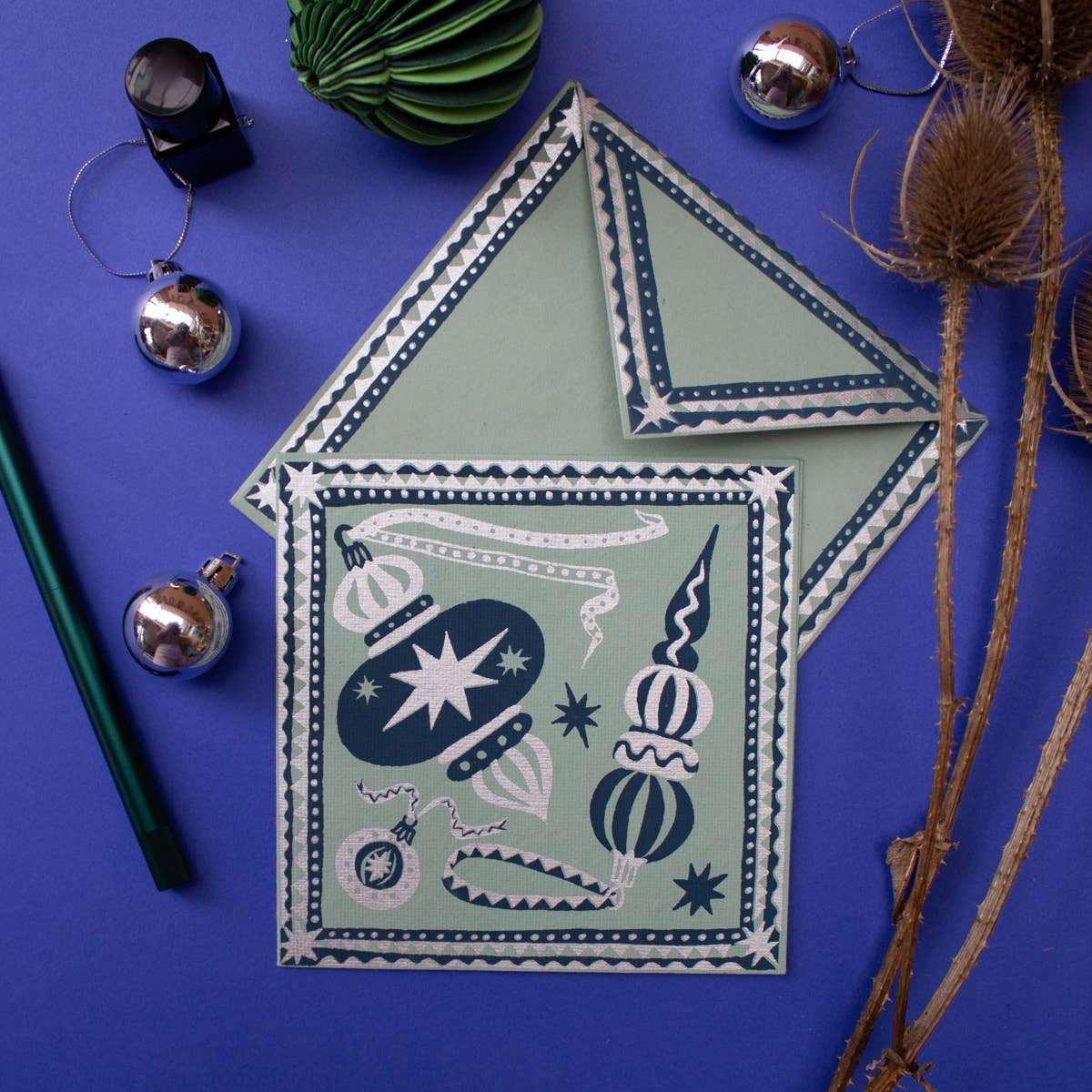 Decorative house-shaped card with festive design on a blue background