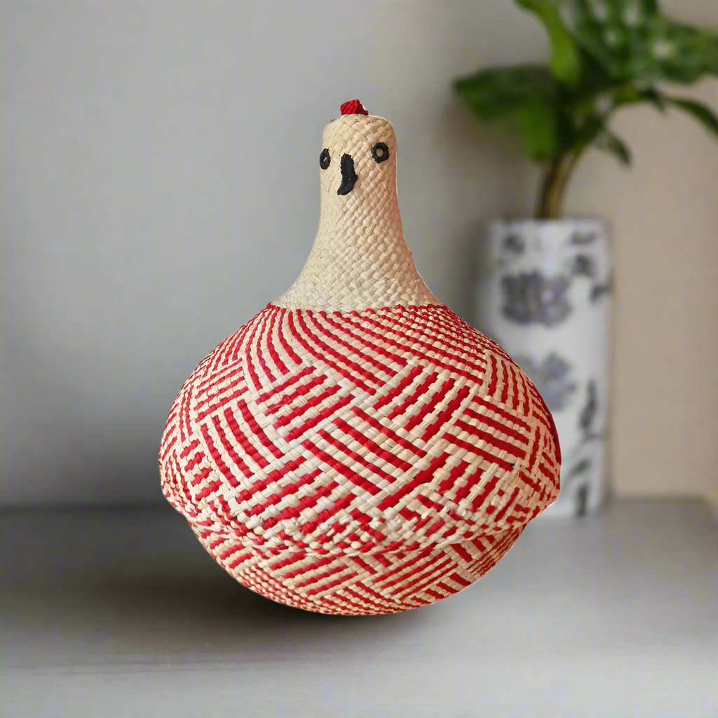 woven red and beige basket with chicken design on a neutral background