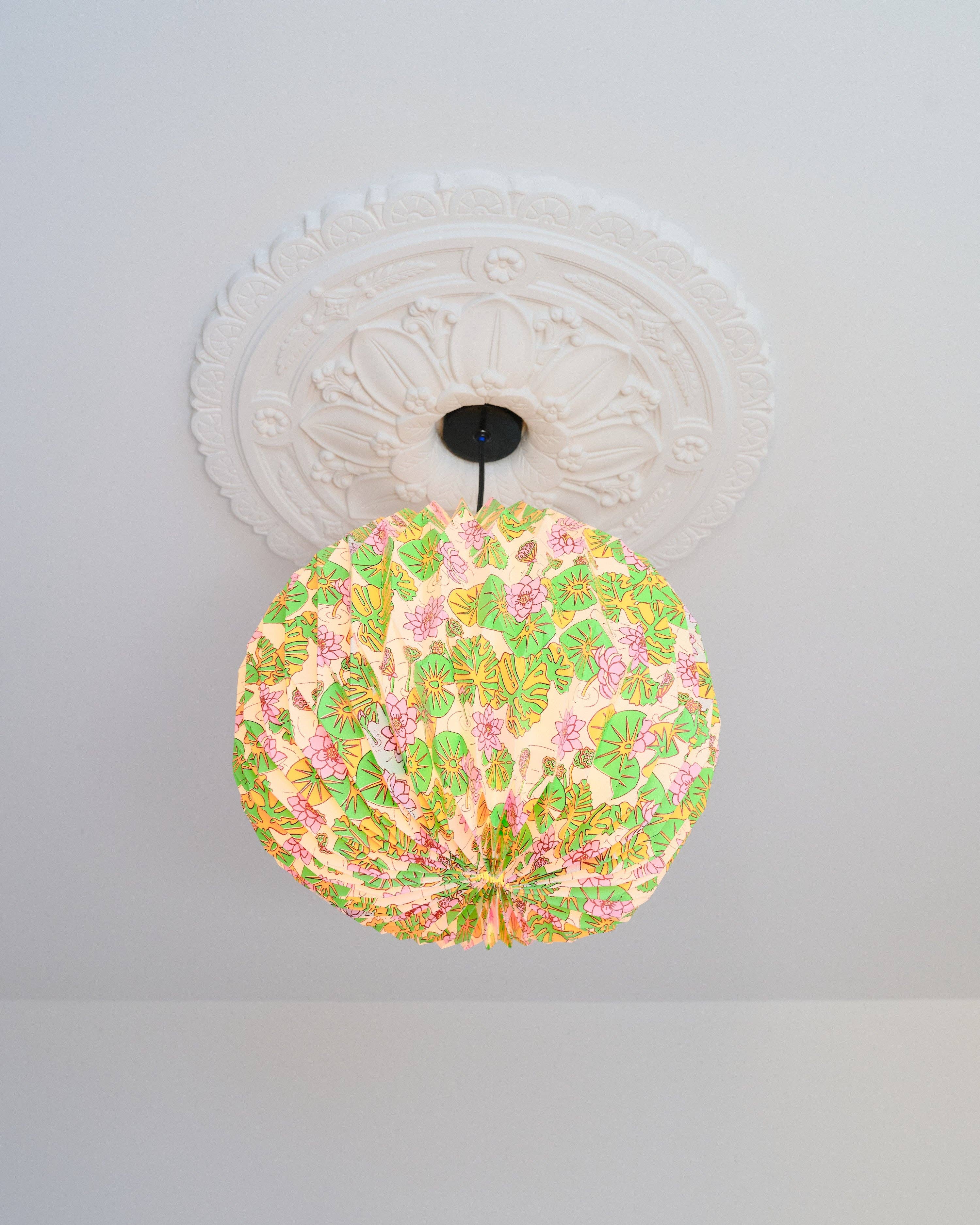 Decorative ceiling light fixture with floral pattern on a white ceiling.