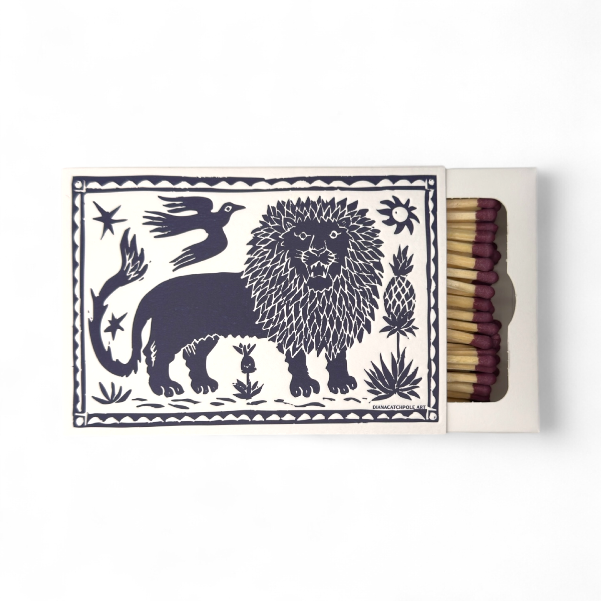 Matchbox with a decorative design featuring a lion, birds, and plants on a white background.