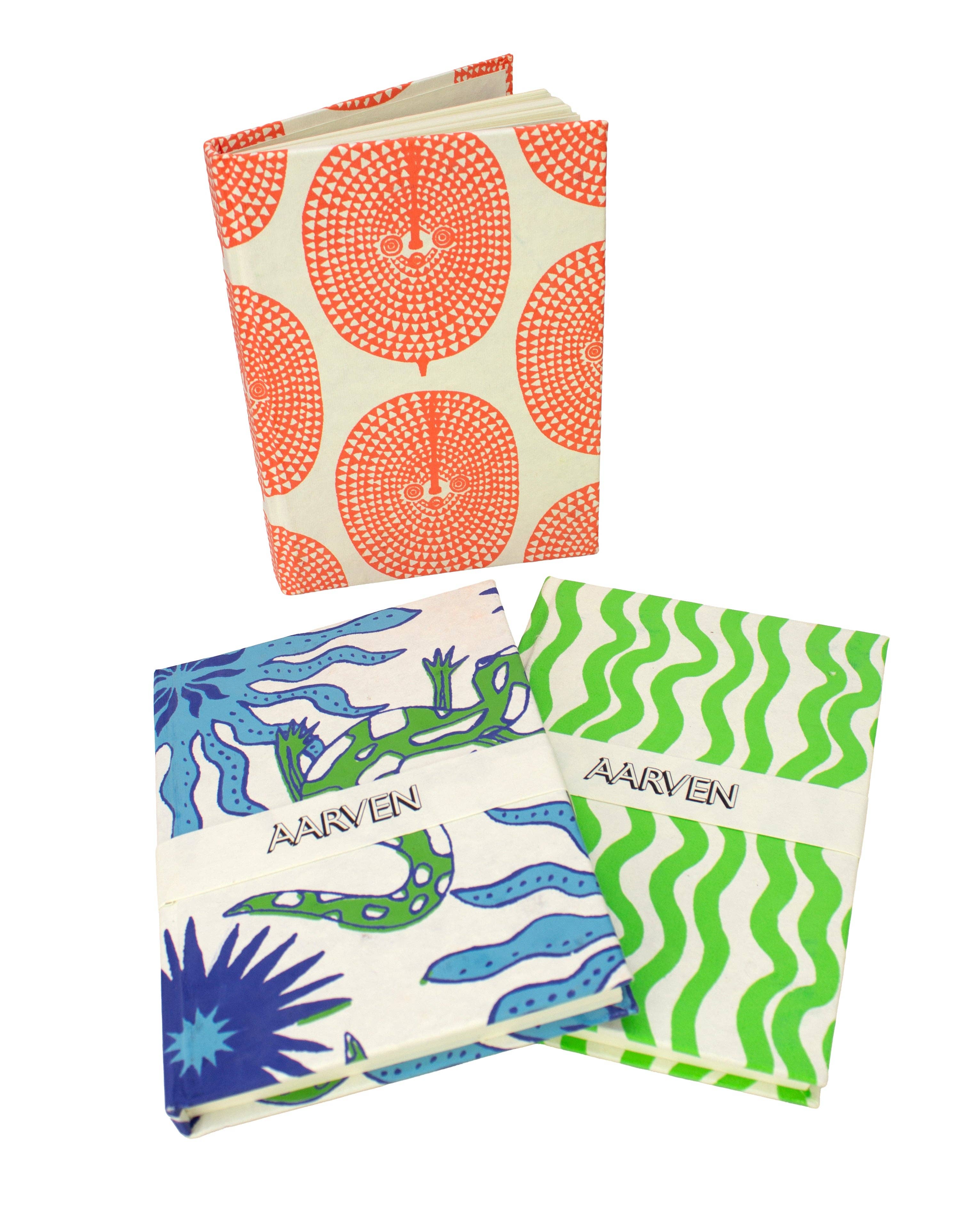 Four colorful patterned books with visible branding on a white background