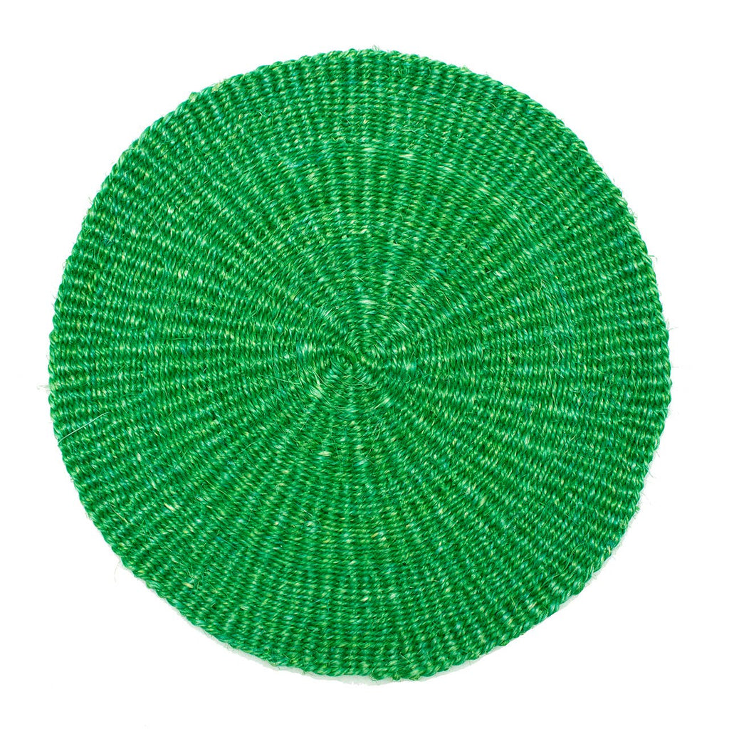 Green woven round placemat on a white background
