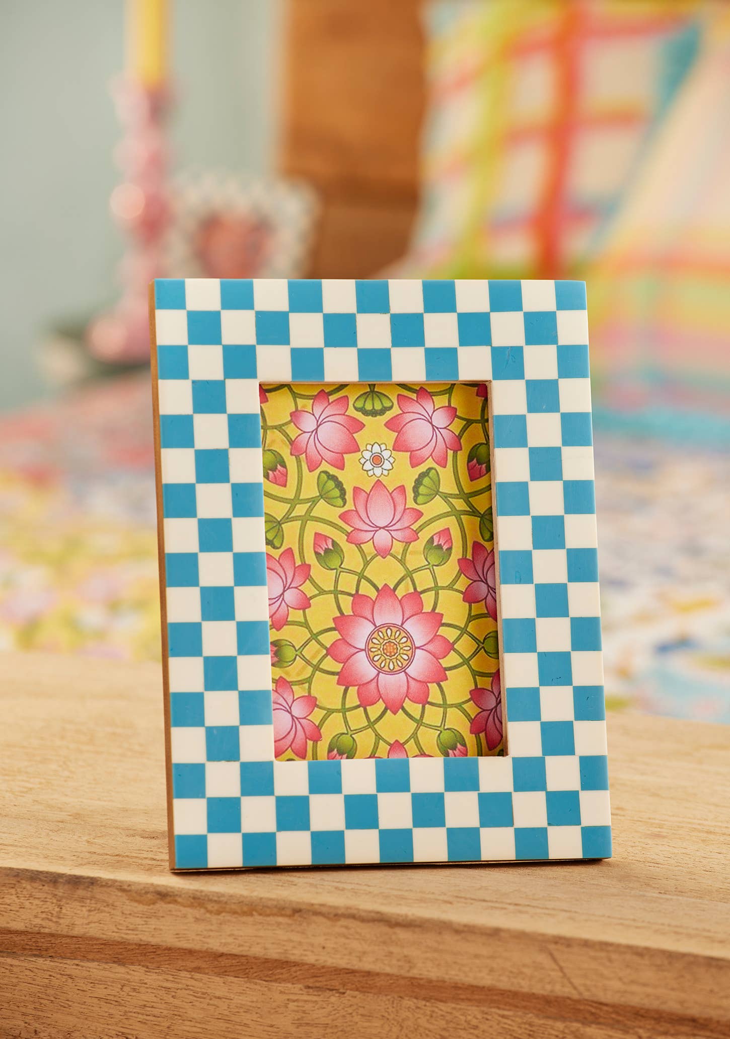Checkered photo frame with floral picture on a wooden surface
