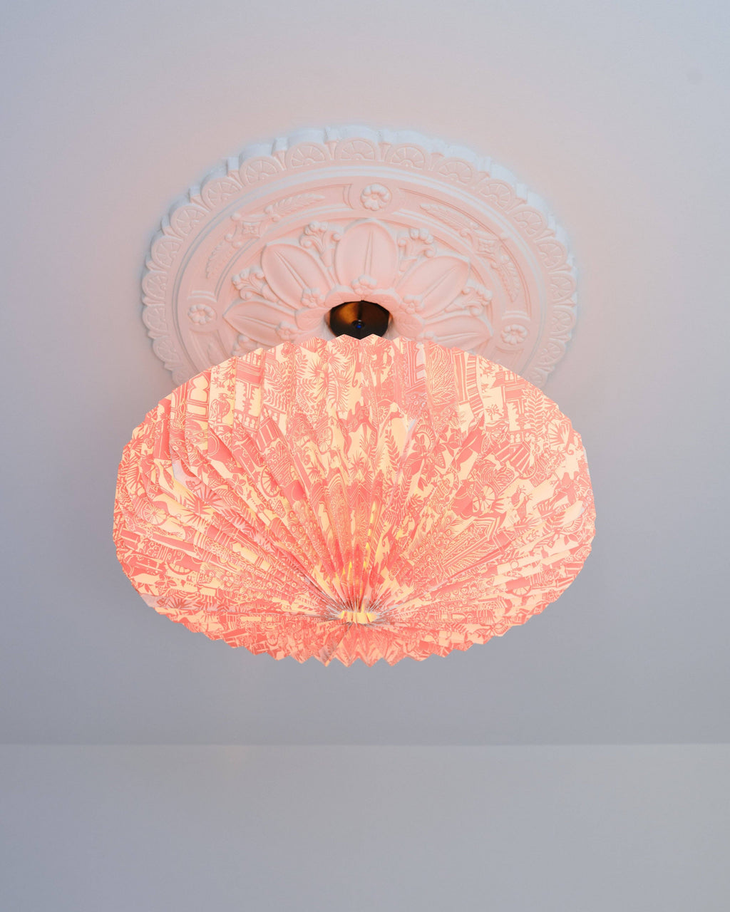 Pink ceiling light fixture on a white ceiling