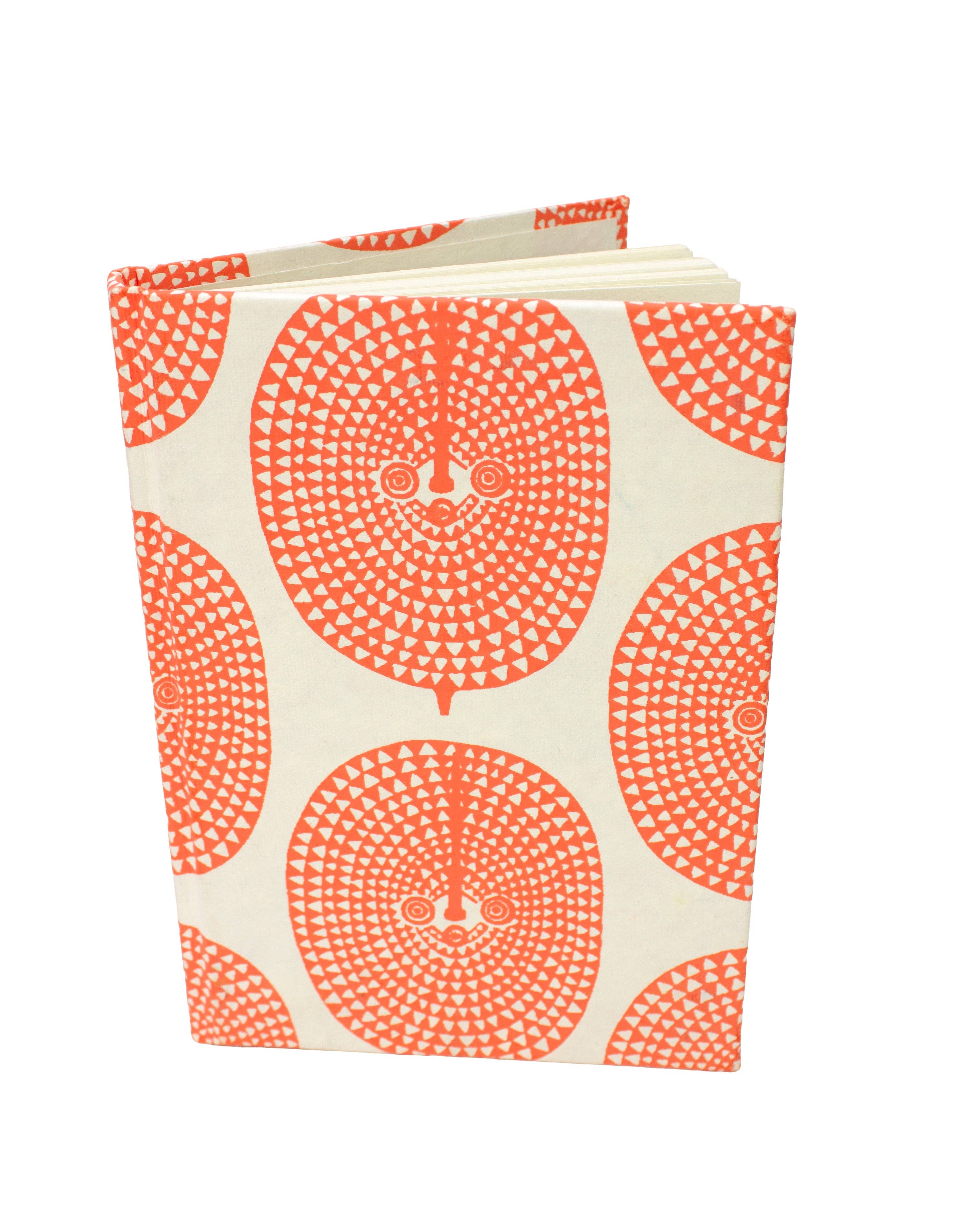Notebook with orange circular pattern on a white background