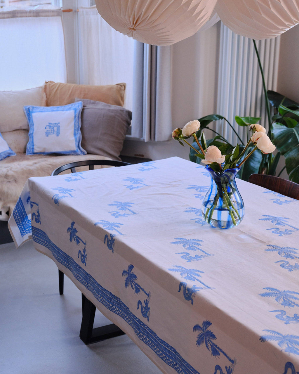 Tablecloth with blue patterns on a table in a living room setting.