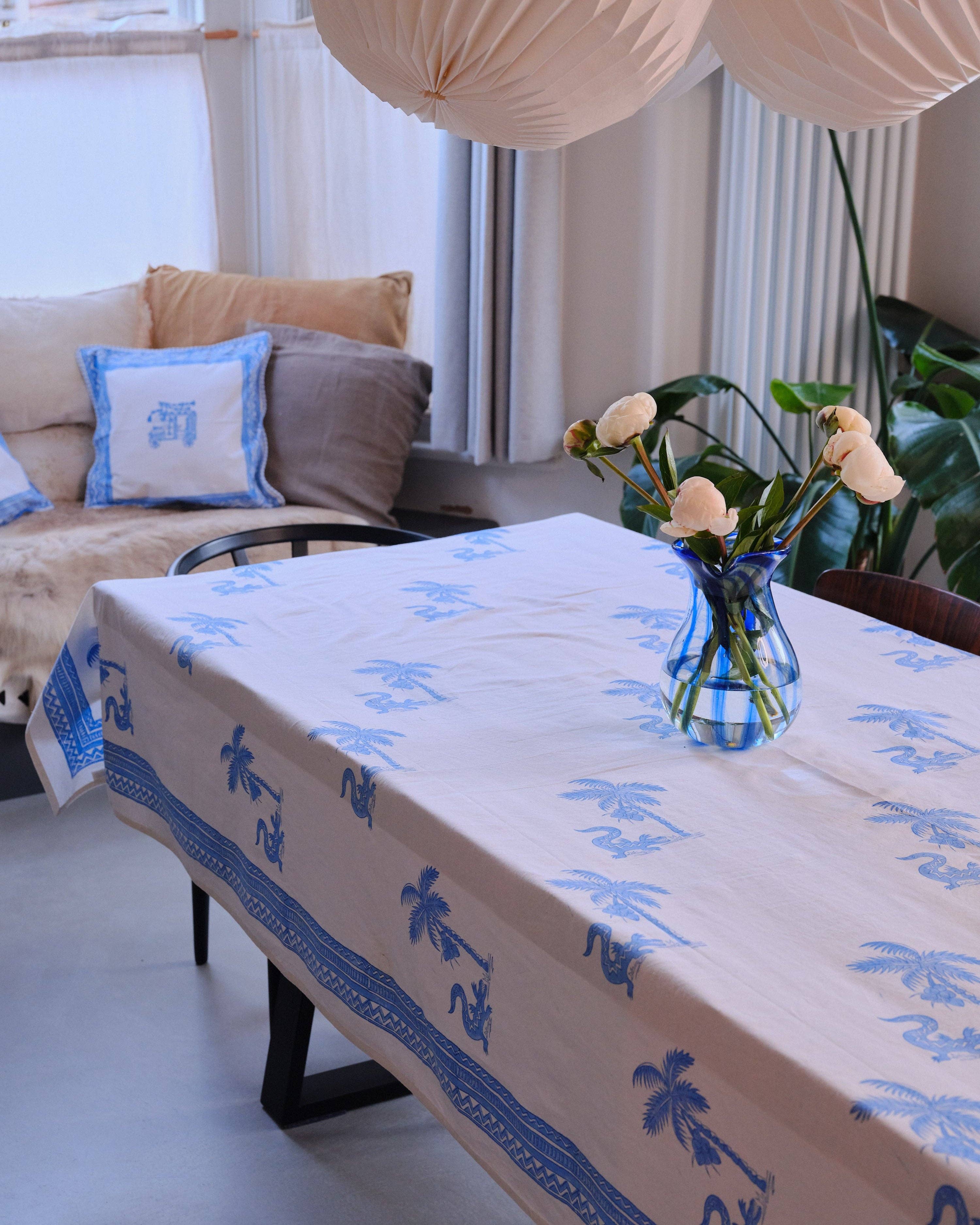Tablecloth with blue patterns on a table in a living room setting.