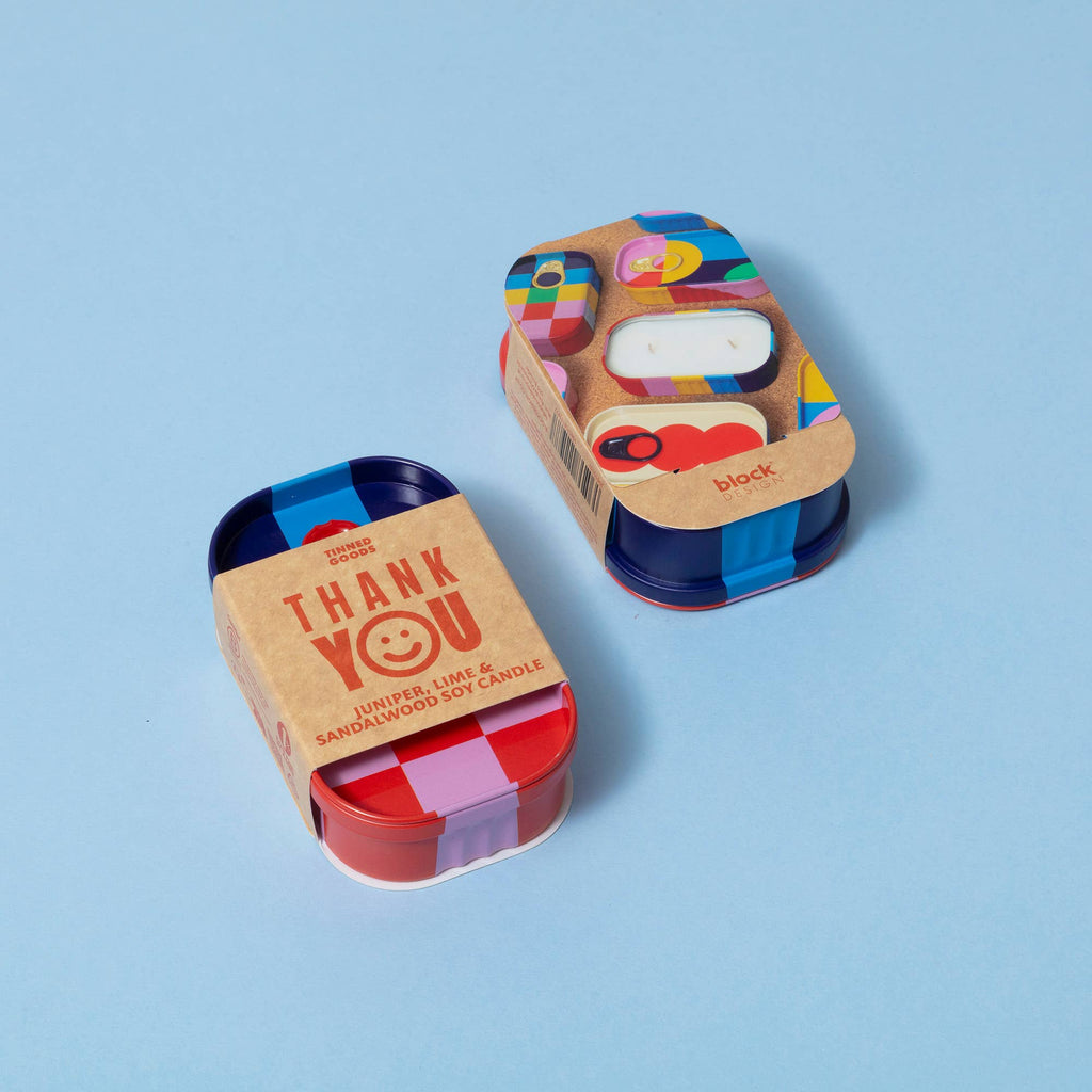 Two colorful candle sets in packaging on a blue background