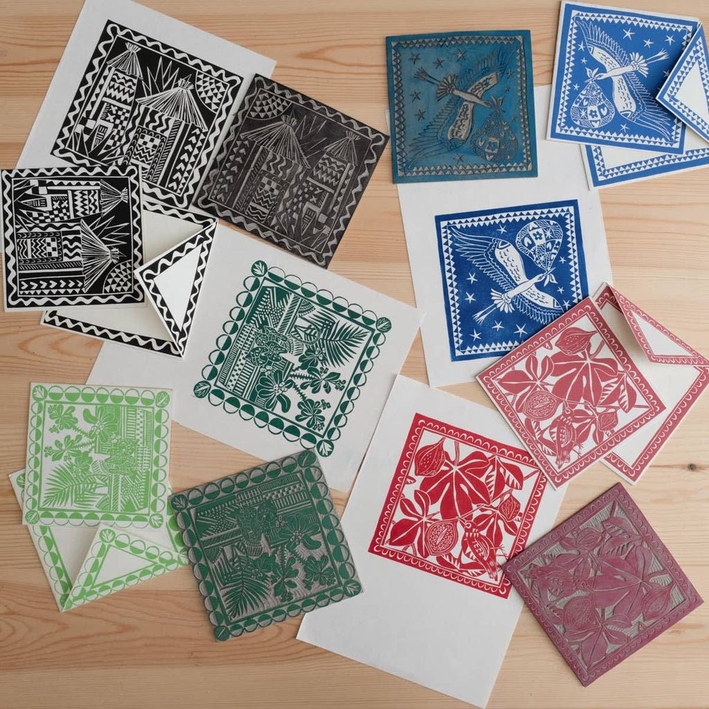 Collection of colorful paper cutouts on a wooden surface