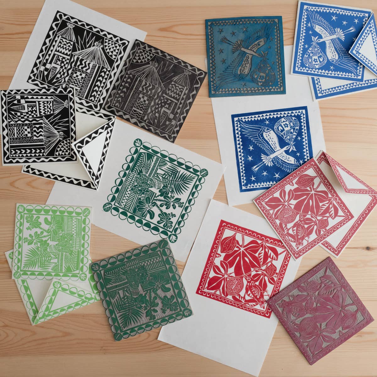 Collection of colorful paper cutouts on a wooden surface