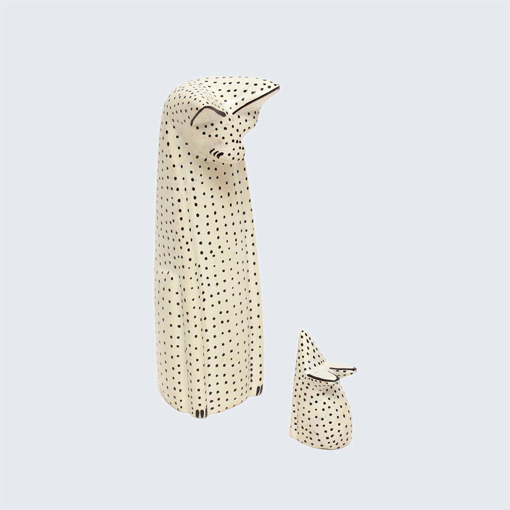 Two polka dot soapstone animals items on a light gray background