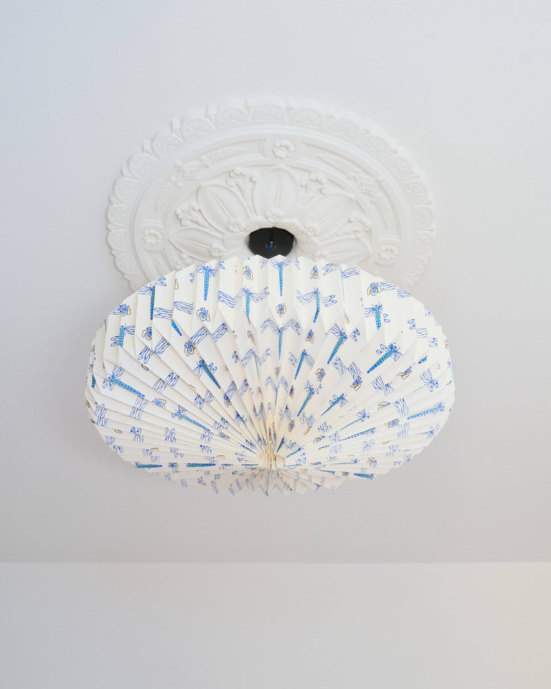 White ceiling light fixture with blue dragonfly design on a white background