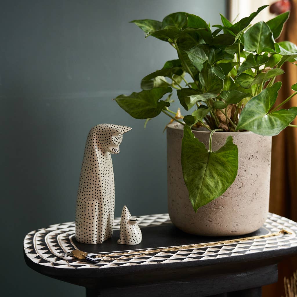 Decorative table with a soapstone cat and mouse figurines in a polka dot pattern