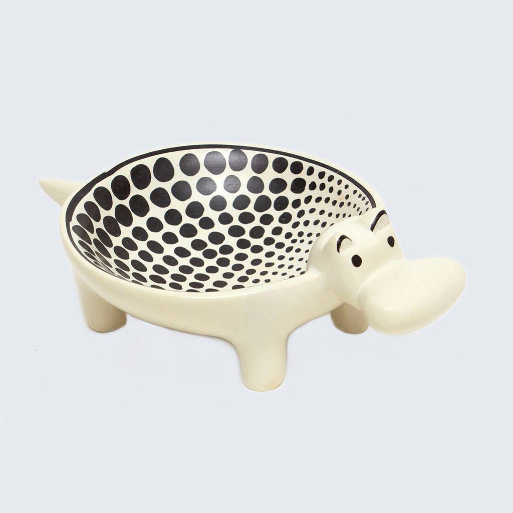 Decorative bowl shaped like a hippo with a black dot pattern on a light gray background