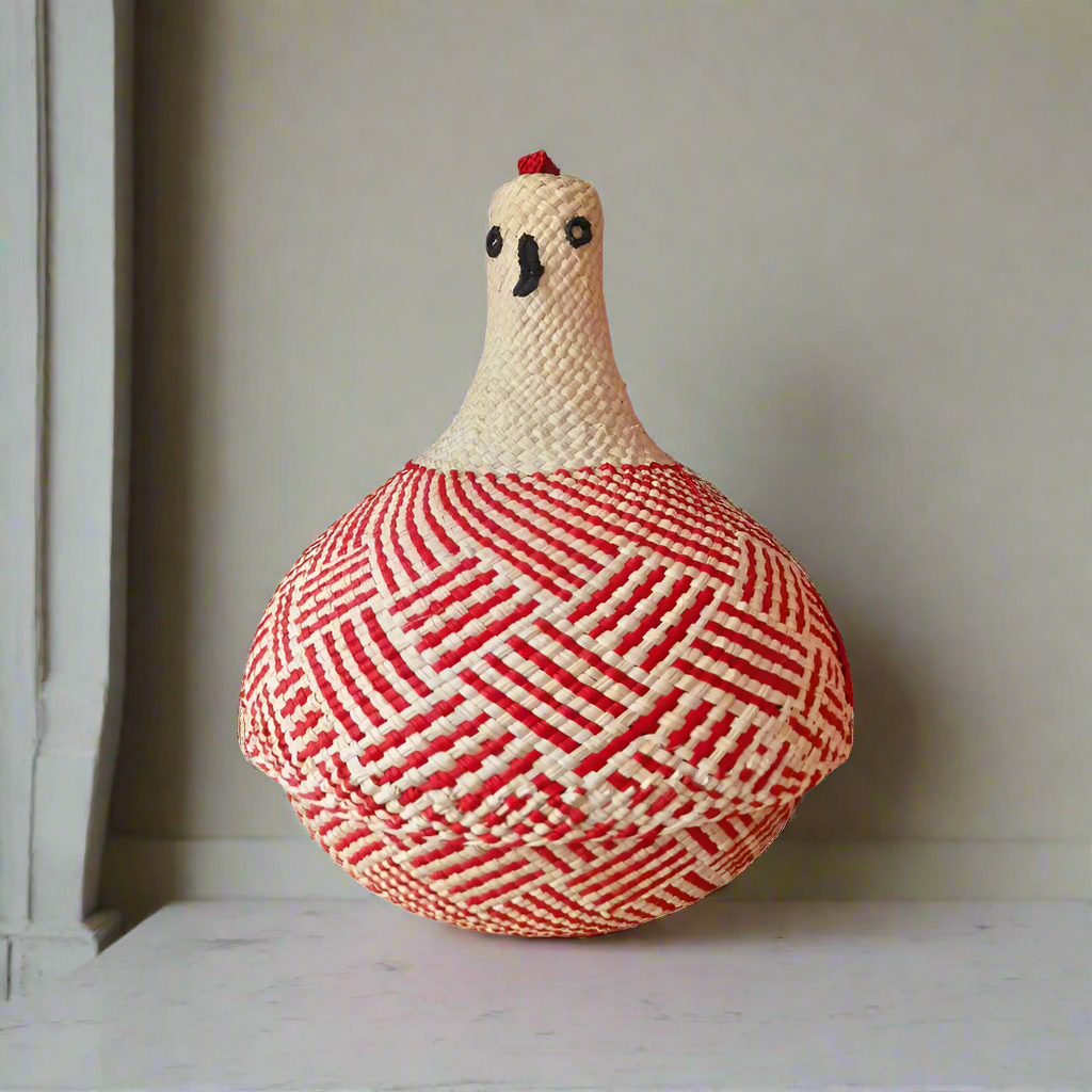 Hand-woven chicken-shaped basket with red and white pattern on a neutral background