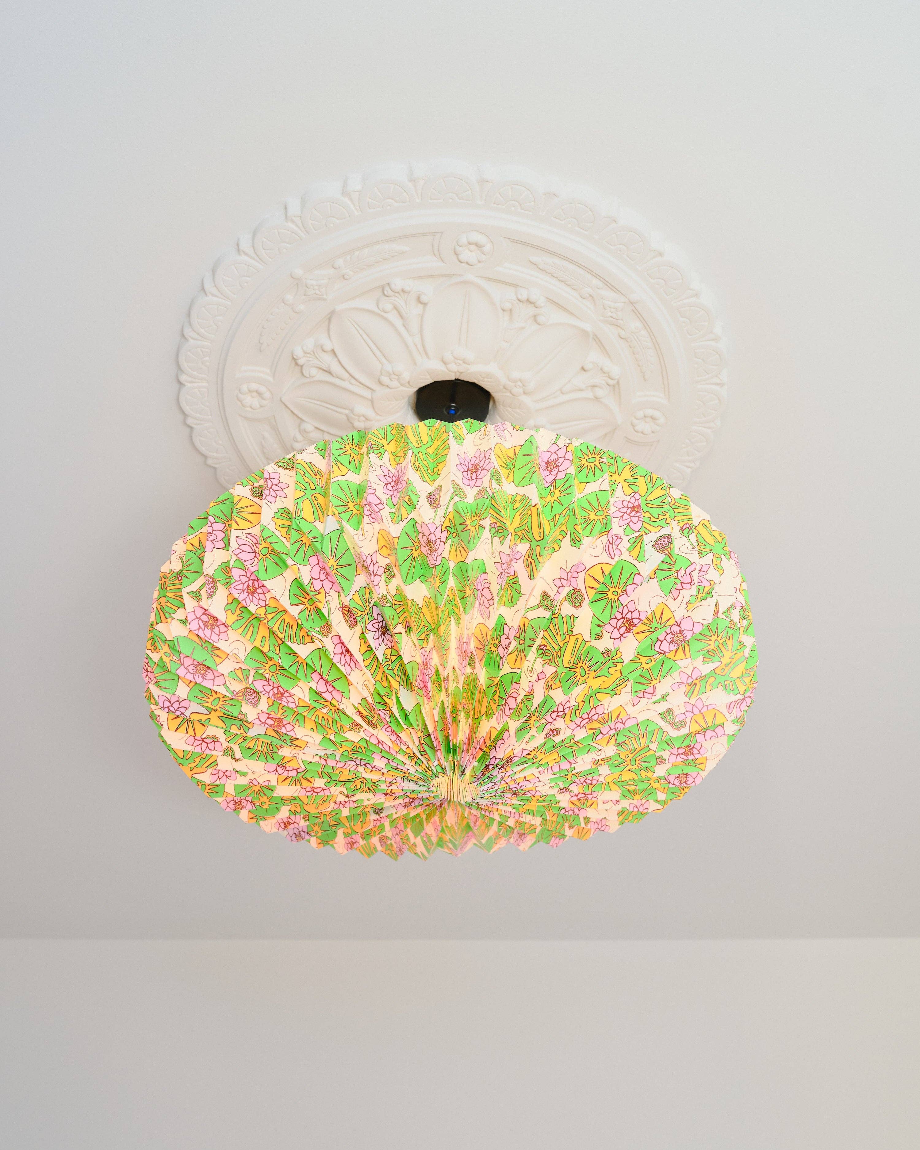 Decorative ceiling light fixture with floral pattern on a white ceiling