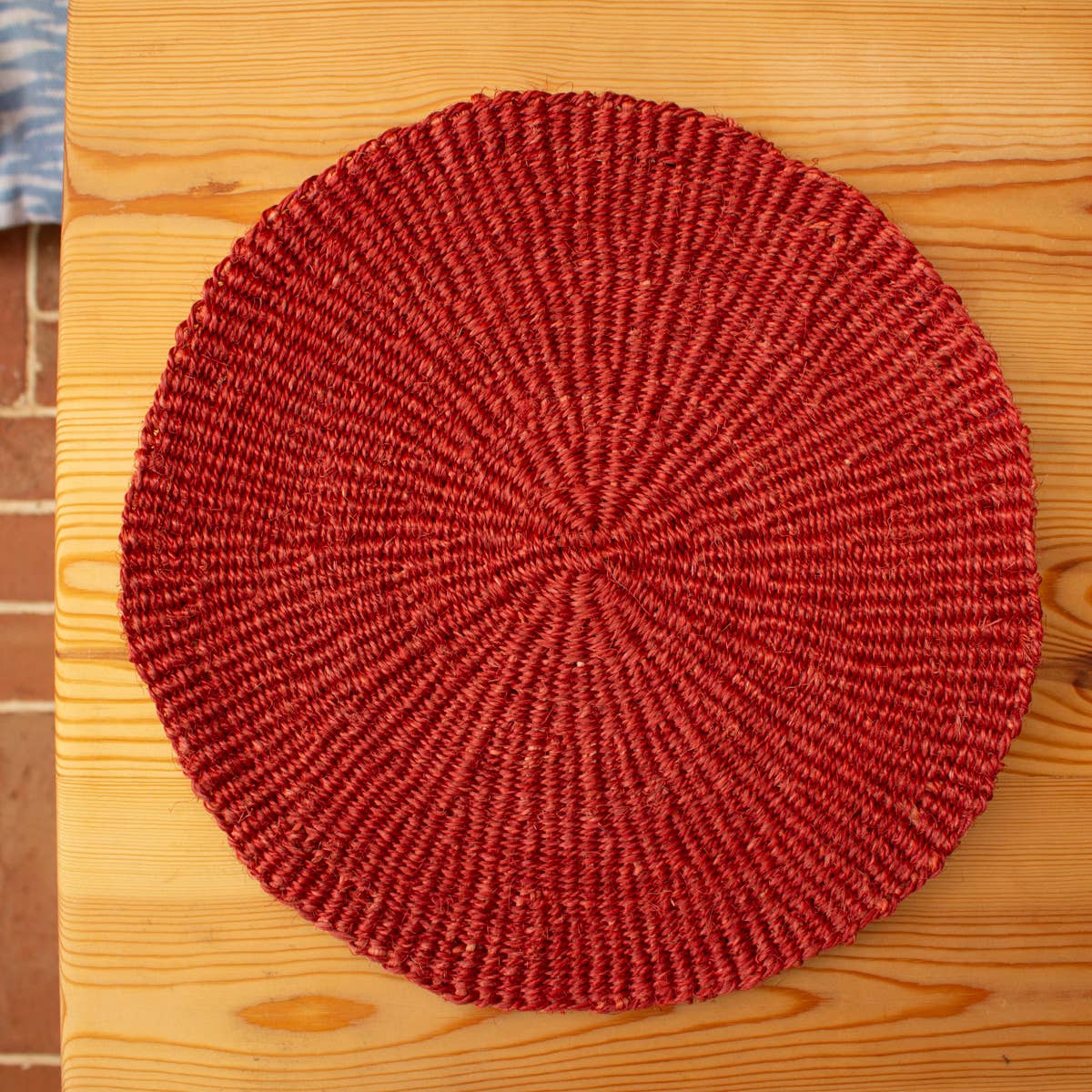 Red woven mat on a wooden surface