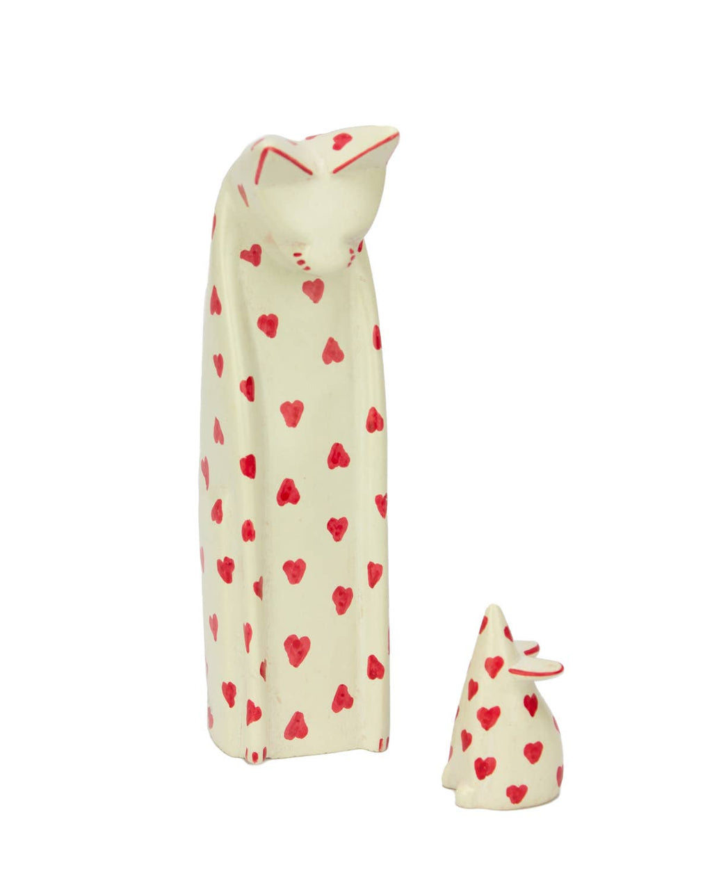 Two soap stone animals with red heart patterns on a white background