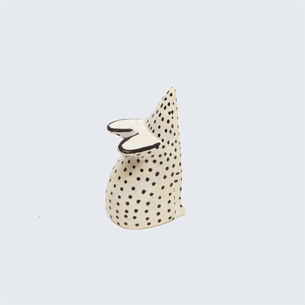 Decorative soapstone mouse with black polka dots on a light gray background